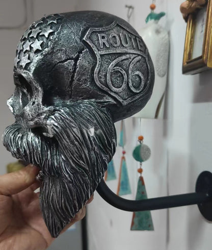 Decorative helmet holder with skull made of synthetic resin